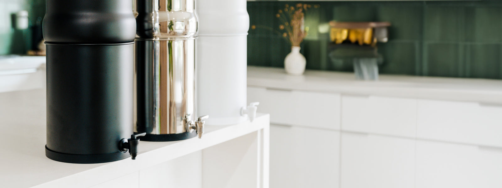 Three BOROUX legacy water filtration systems on kitchen countertops