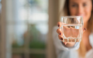 Woman offering a glass of water