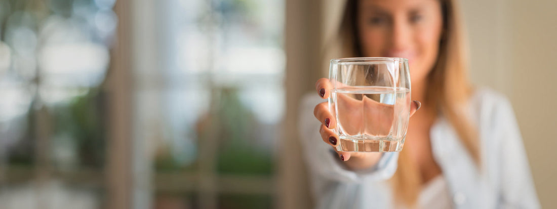 Woman offering a glass of water