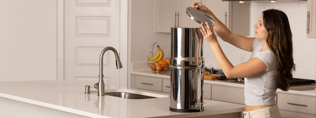 Woman placing lid on a BOROUX legacy water filter system