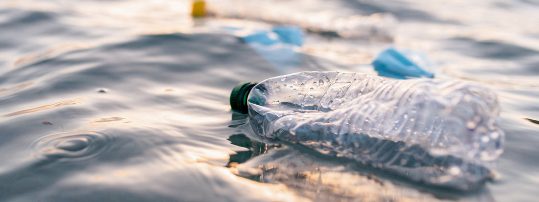 A bottled water bottle floating on a body of water