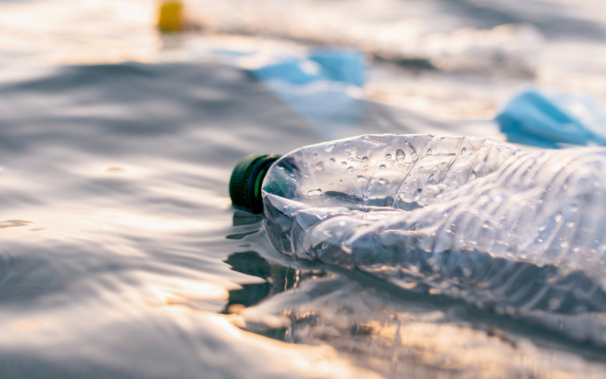 A bottled water bottle floating on a body of water