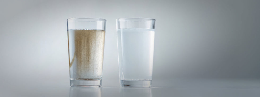 Glass of contaminated water that contains glass of water with sediment and silt