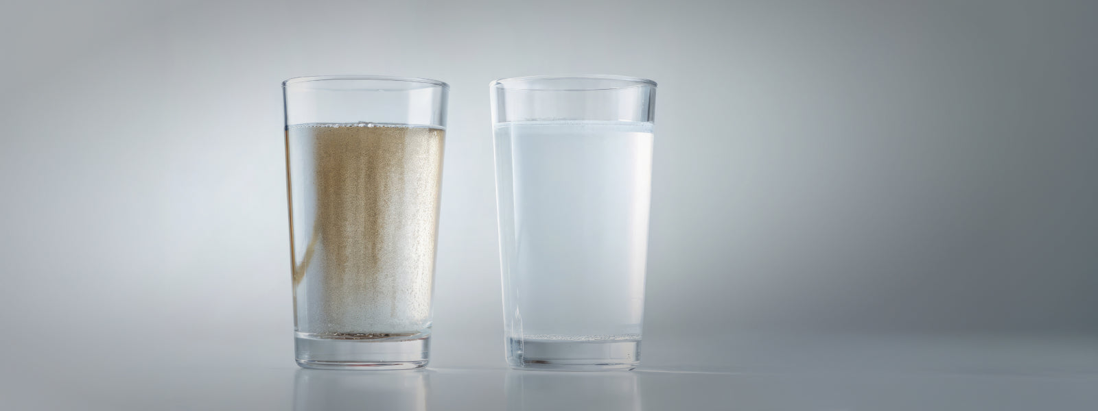 Glass of contaminated water that contains glass of water with sediment and silt