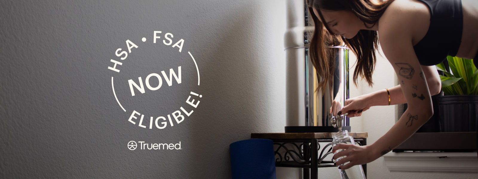 Female refilling her glass bottle using a BOROUX filter system Use HSA/FSA Fund to Buy BOROUX